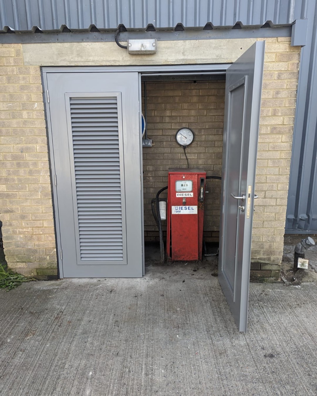 New steel security door being installed at a Cardiff property